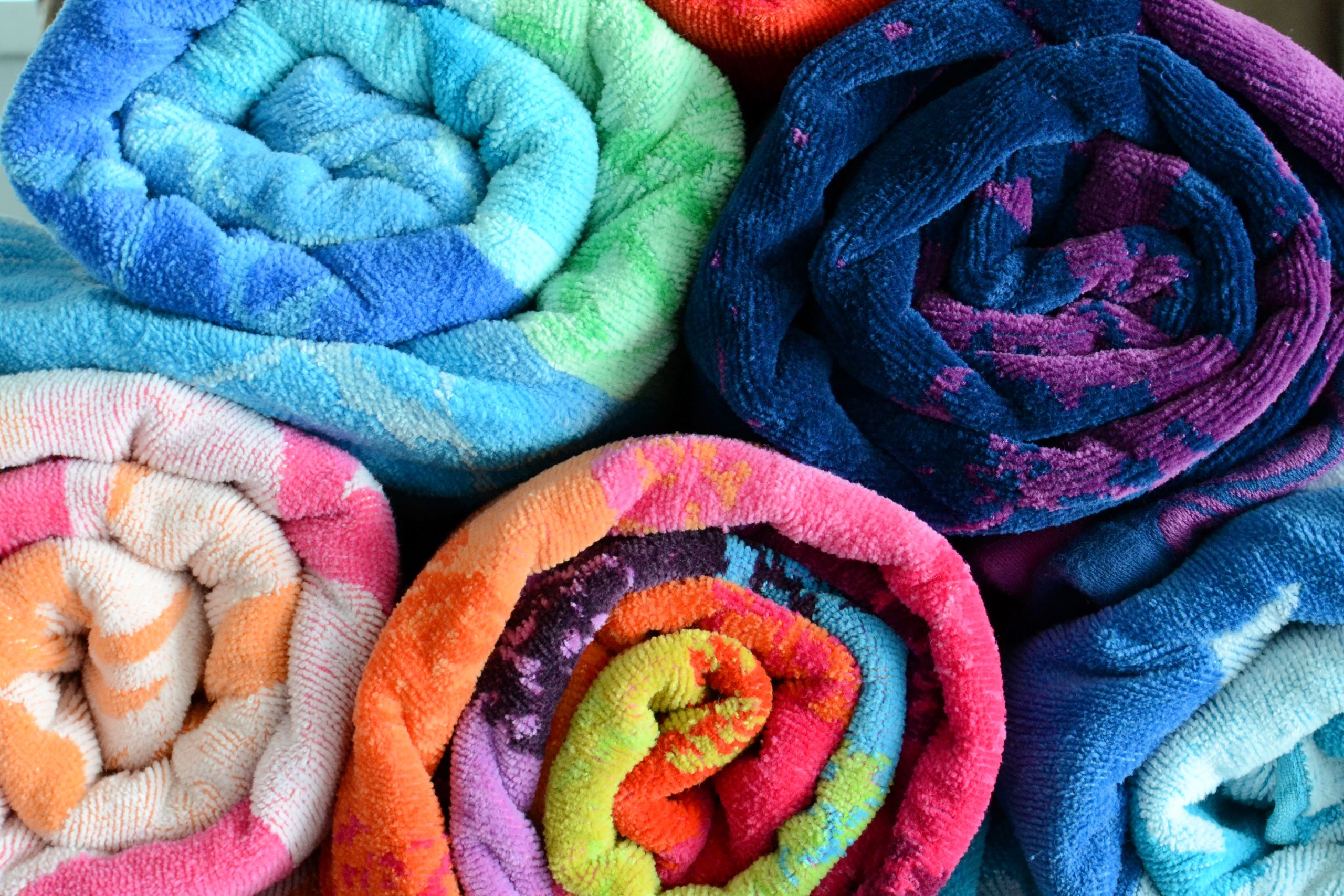 Blog 4 bright and colorful rolled beach towels stacked on 2025 03 11 18 38 57 utc