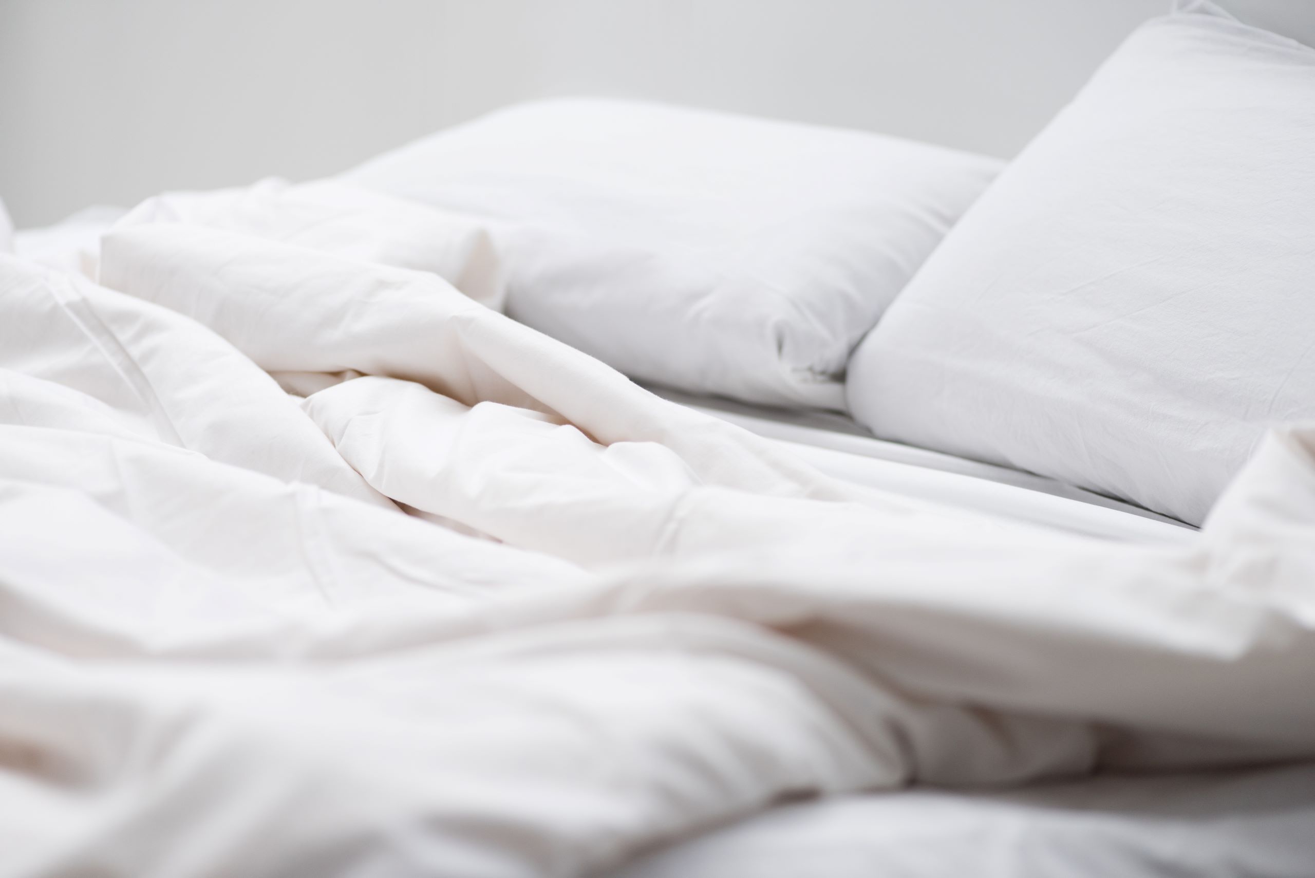 Blog 2 selective focus of bed with white pillows and blan 2024 11 17 05 37 52 utc