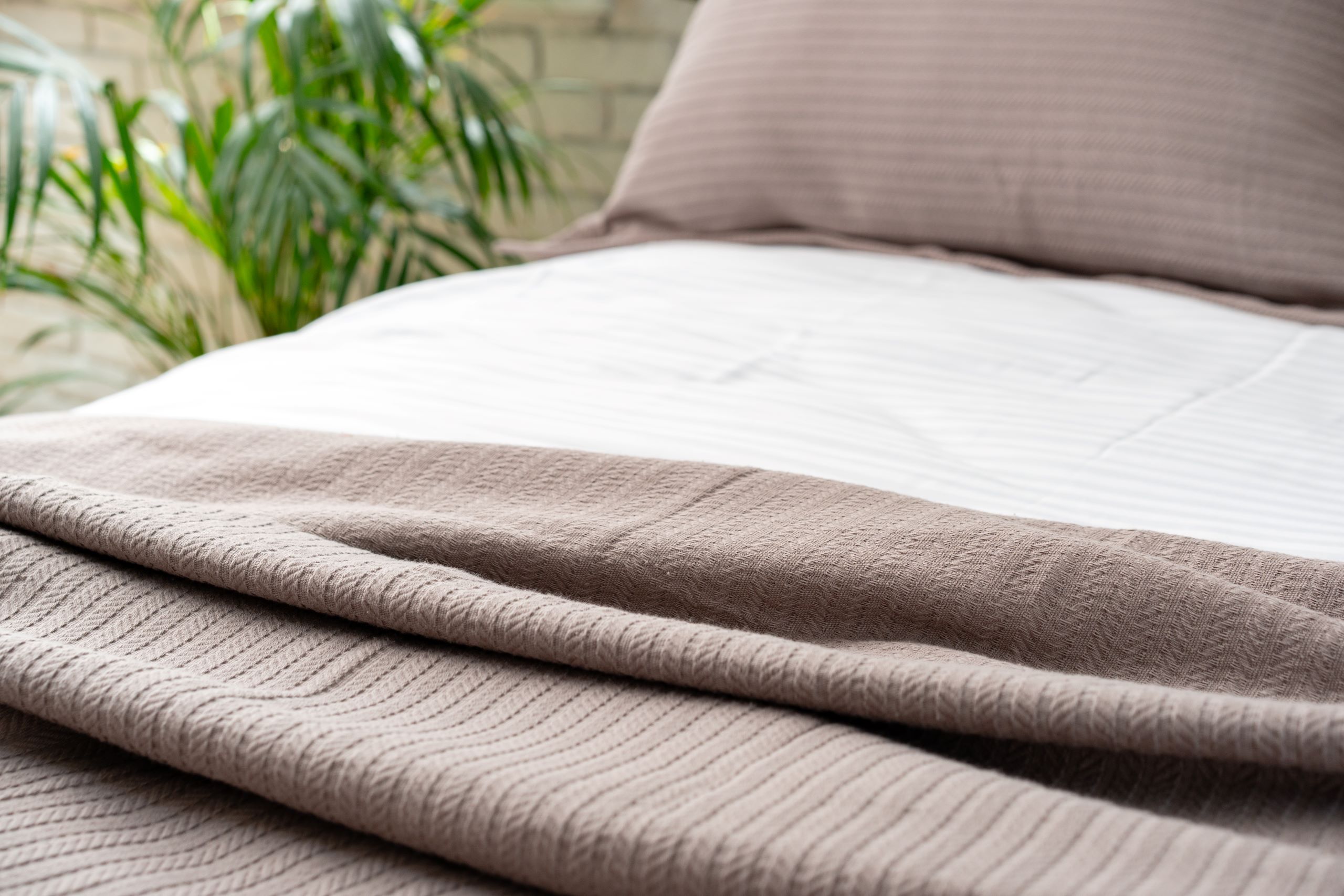 soft brown knit blanket on a made bed 2025 02 25 04 09 20 utc